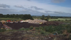 Green waste compost piles - note waste lorry for scale